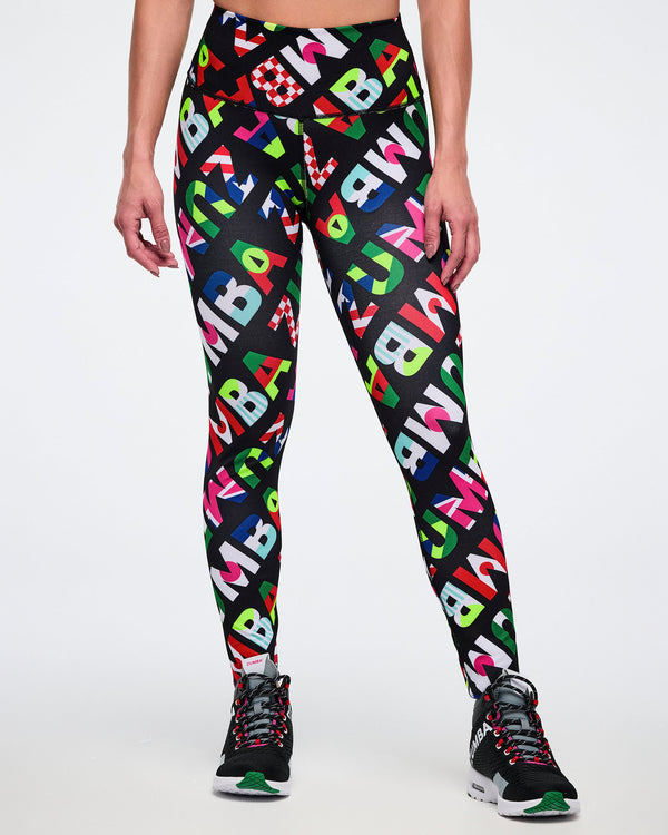 Female model from the front, wearing leggings with colorful flag-like pattern, on a white background