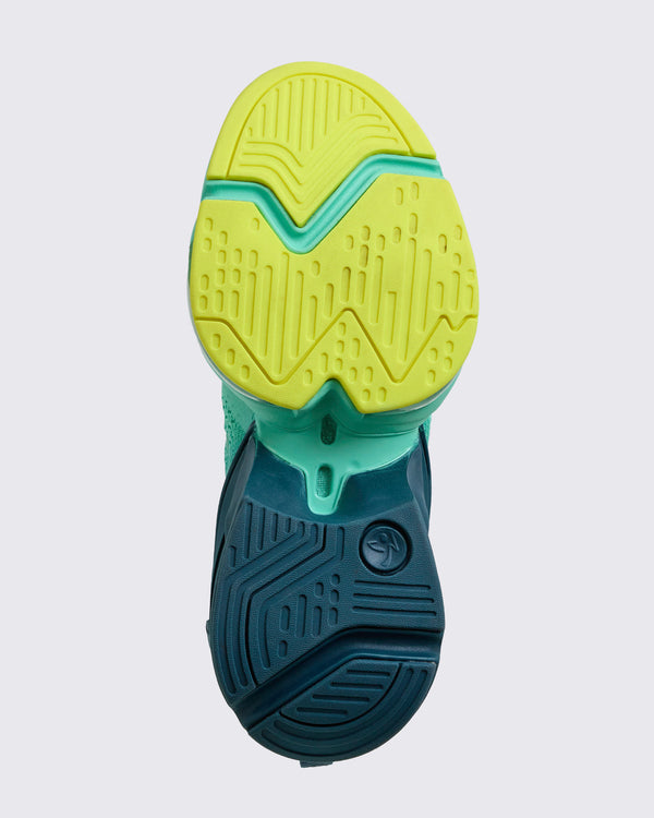 Bottom-up view of the outsole showing yellow forefoot tread, teal midfoot bridge, and navy heel traction pattern, on a light gray background.