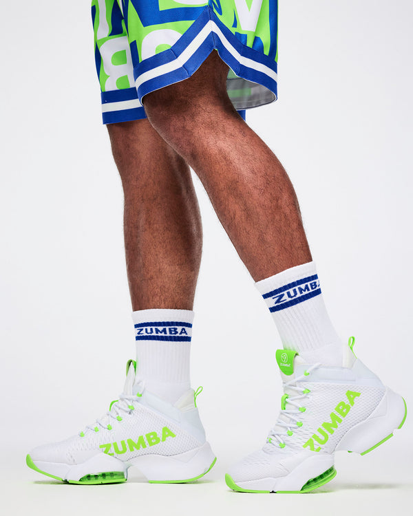 Close-up of male model in L white and blue Zumba socks paired with white and green shoes.