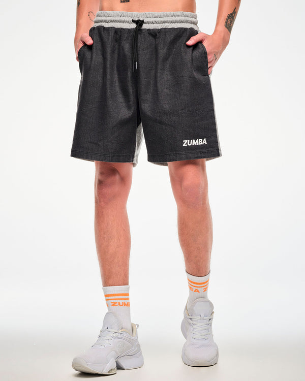 Male model wearing black and grey colorblock shorts with white