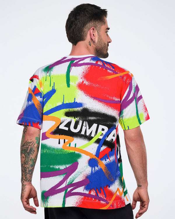 Back view of a male model wearing a colorful Zumba t-shirt with abstract designs on a white background.