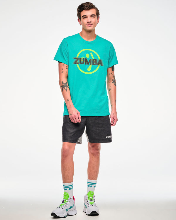 Male model wearing an aqua tee with a yellow Zumbito logo and halftone black dot