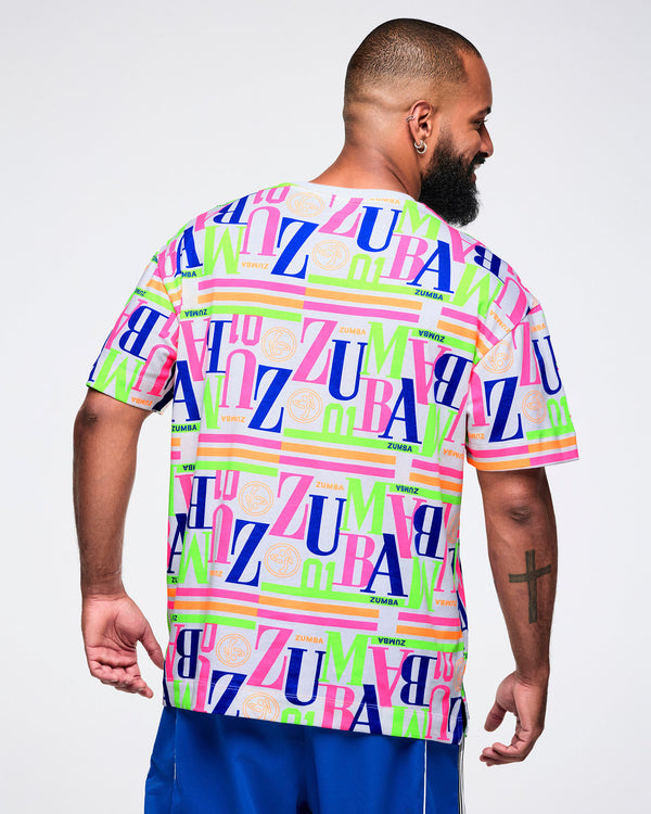 Back view of a male model wearing a colorful 'Zumba' t-shirt on a white background.