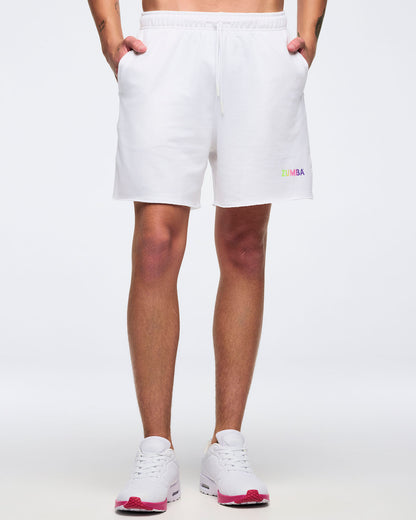 Man in white shorts that are just above the knees, with small Zumba text on the left leg on a white background.