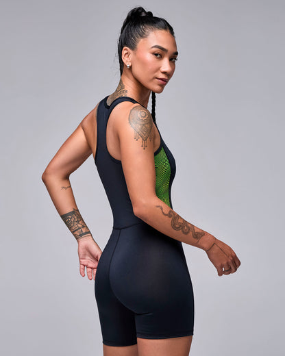 Shown from the back, the black biker bodysuit with a racerback, the wavy check print side panel, and a smooth fit through the seat.