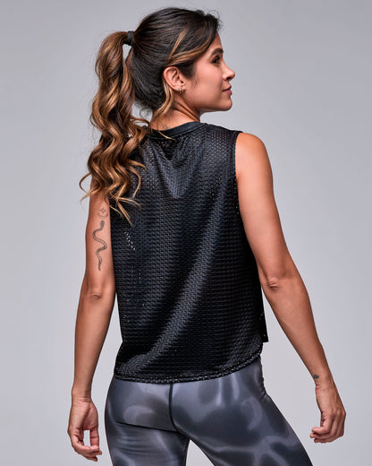 Shown from the back, the black loose mesh 'STRONG iD' muscle tank, with a plain open-hole mesh back and relaxed fit over black and grey swirl print leggings.