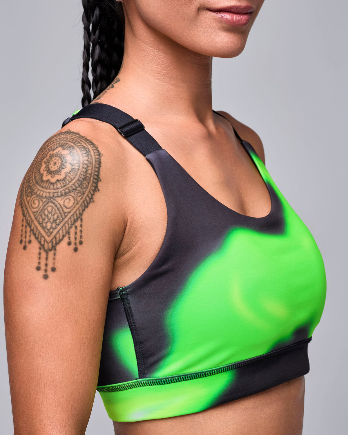 Close-up of the swirl print bra in side view, showing the black adjustable strap and smooth scoop neckline.