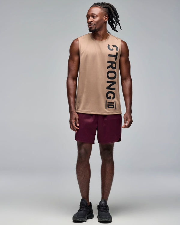 Taupe sleeveless athletic tank with a crew neckline and oversized vertical black 
