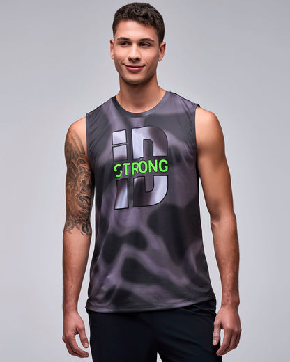 Male model in a black and grey swirl print wide shoulder tank with a large grey 'iD' graphic outlined in black and neon green 'STRONG' text across the middle, paired with black pants.