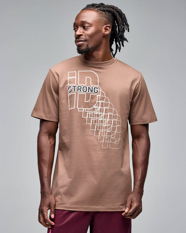 Taupe short-sleeve T-shirt with a white geometric “STRONG ID” front graphic, shown on a male model wearing burgundy athletic shorts against a light gray studio background.