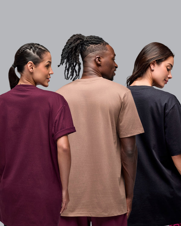 Taupe short-sleeve T-shirt with a plain back, shown from the back on a female model in burgundy, a male model in taupe, and a female model in black against a light gray studio background.
