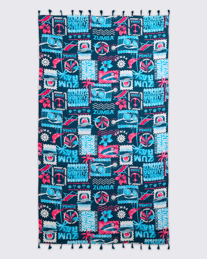 Navy Zumba beach blanket or towel with tassel trim and an allover teal-and-pink tropical collage print featuring sunglasses, flowers, waves, and logos, laid flat.
