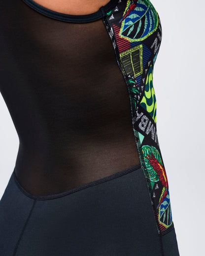 Close-up of the bodysuit’s sheer black mesh back panel with a curved seam and colorful printed side insert.