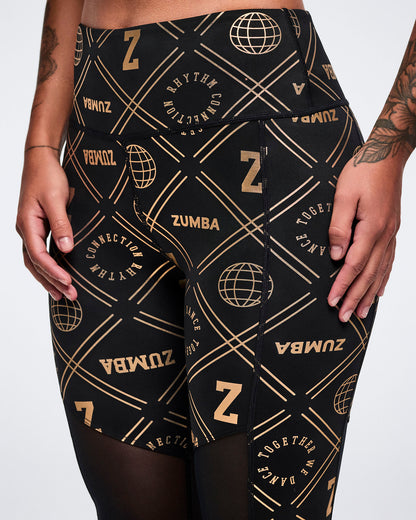 Close-up of Zumba leggings with gold patterns on a white background.