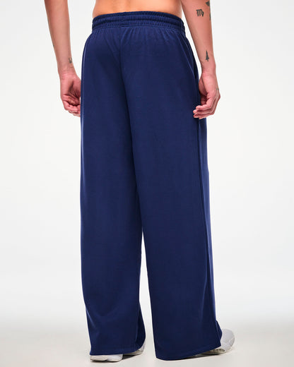 Back view of a male model in the navy straight-leg pants, showing the elastic waistband and full-length wide legs.