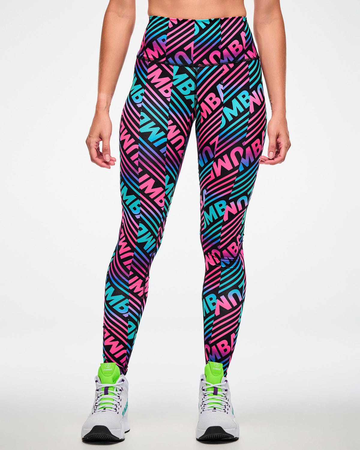 Female model wearing leggings with a bold pink, aqua, and black "ZUMBA" print.