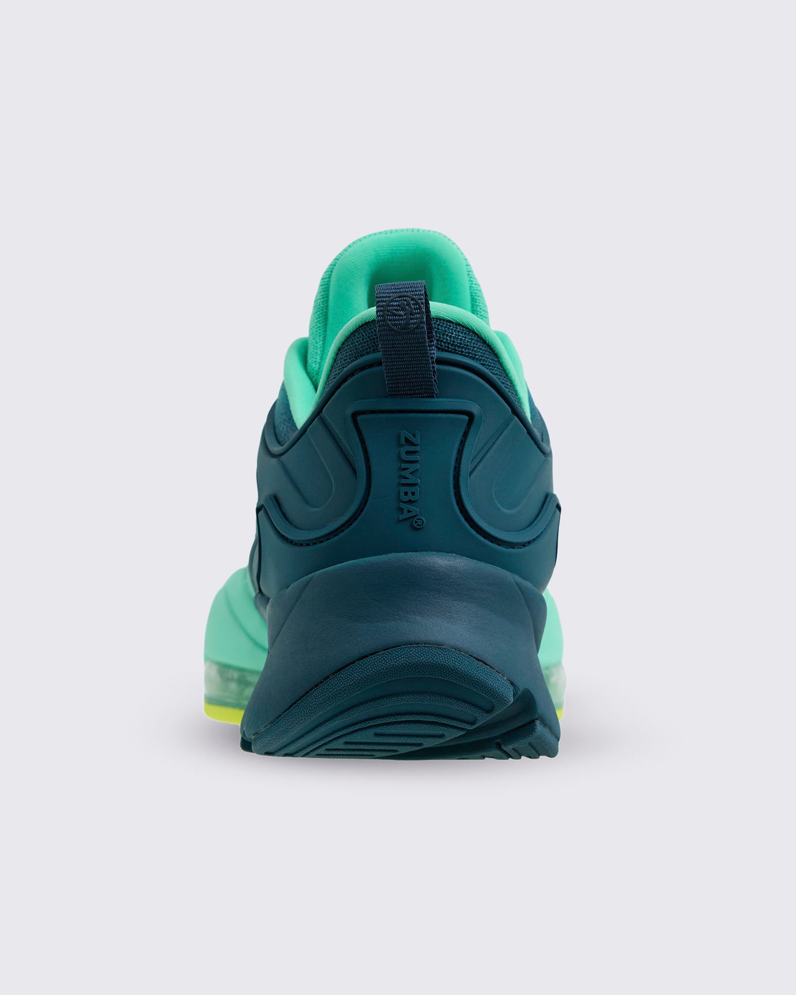 Rear view of the sneaker highlighting the navy heel structure with “ZUMBA” branding, mint inner collar, and thick navy-and-mint heel, on a light gray background.
