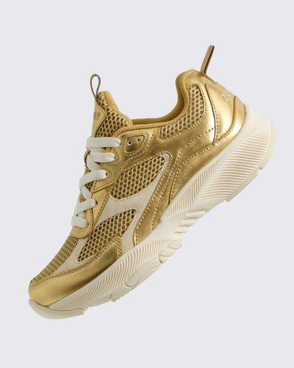 Angled view of the gold and beige bottom sneaker on a light background.