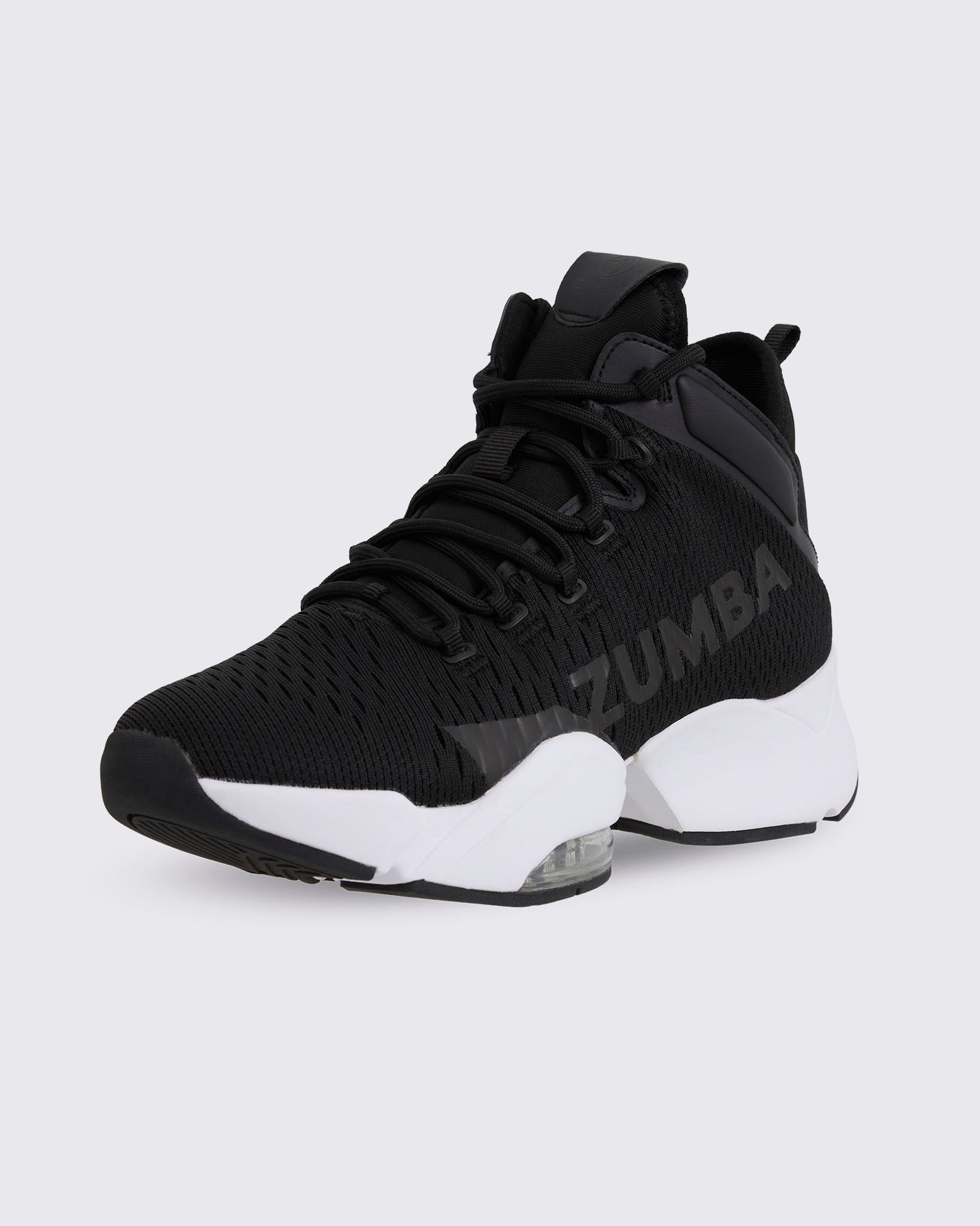 Black Zumba high-top athletic sneaker in a front side view, featuring a knit mesh upper, lace-up front, tonal side logo, and thick white sole with visible air cushioning.
