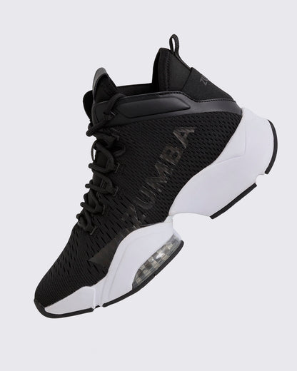 Black Zumba high-top athletic sneaker shown in a side angle, featuring a breathable mesh upper, tonal lace-up closure, glossy black Zumba logo, and chunky white split sole with a visible air cushion.