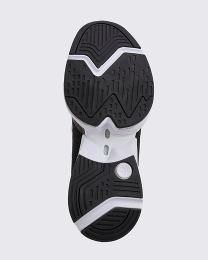 Black Zumba sneaker outsole view, highlighting the full tread pattern, pivot-friendly grooves, and black-and-white split sole construction.
