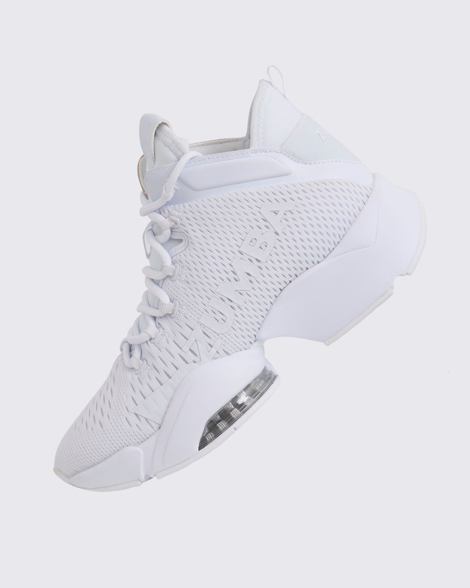 White Zumba high-top athletic sneaker shown from the opposite side, with breathable mesh panels, tonal laces, large Zumba logo, and a sculpted platform sole with a clear air cushion.