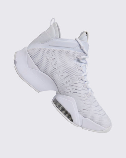 White Zumba high-top athletic sneaker in a side profile, featuring a textured mesh upper, tonal lace-up front, bold side logo, and chunky split sole with a visible air unit.