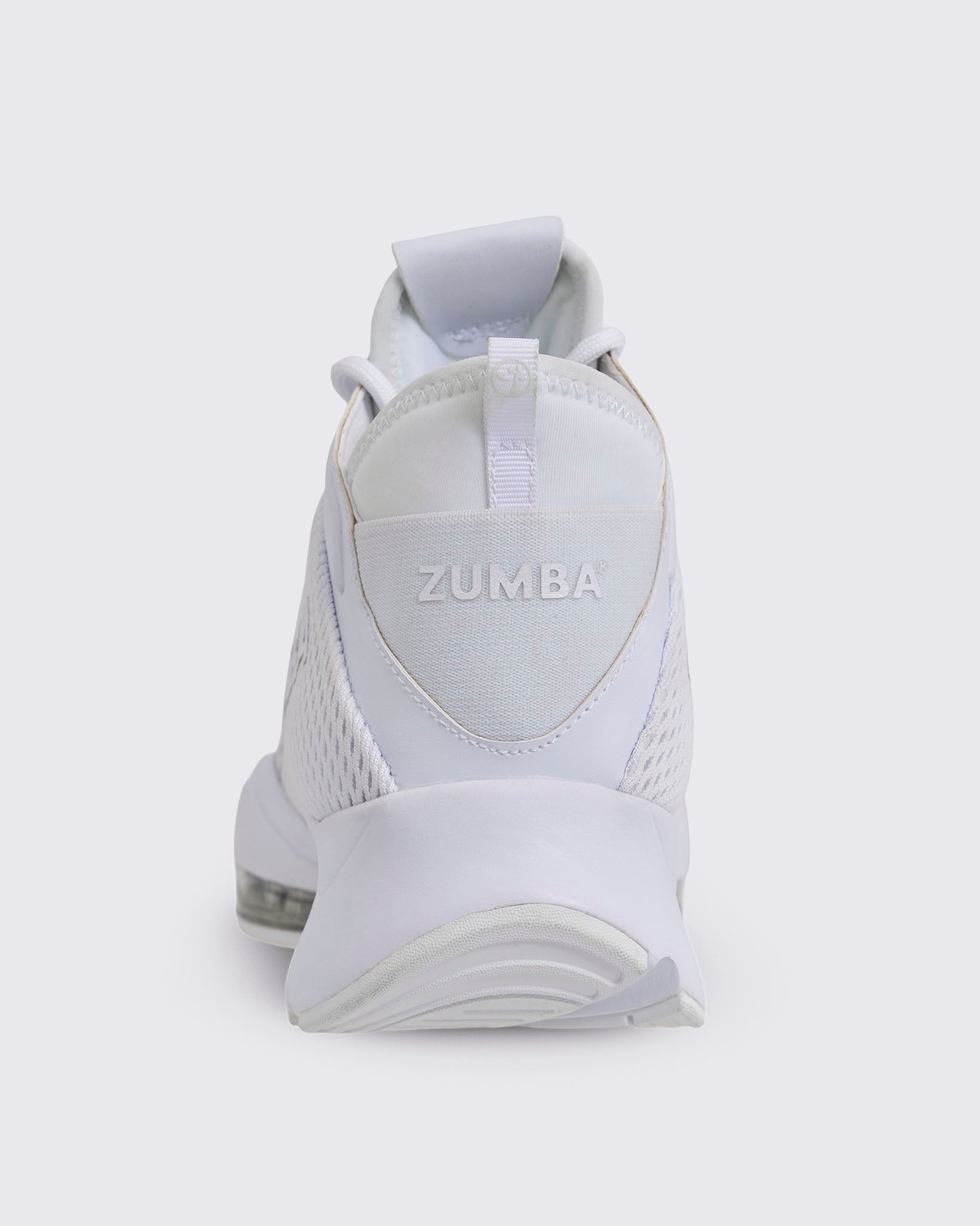 White Zumba high-top athletic sneaker shown from the back, featuring a breathable mesh upper, pull tab, padded heel, and a sculpted sole.
