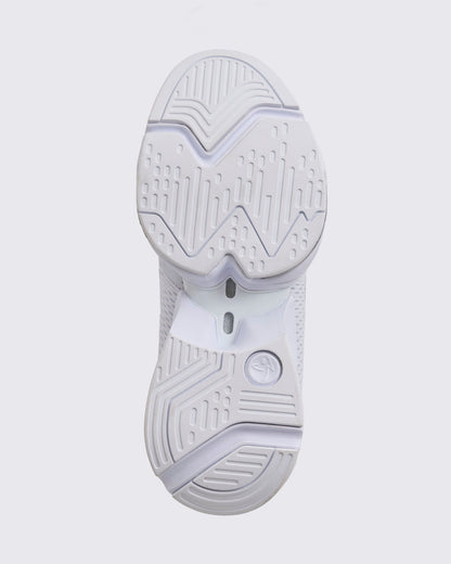 White Zumba high-top athletic sneaker with the outsole facing forward, showing the full tread pattern, pivot-friendly grooves, and supportive split sole construction.