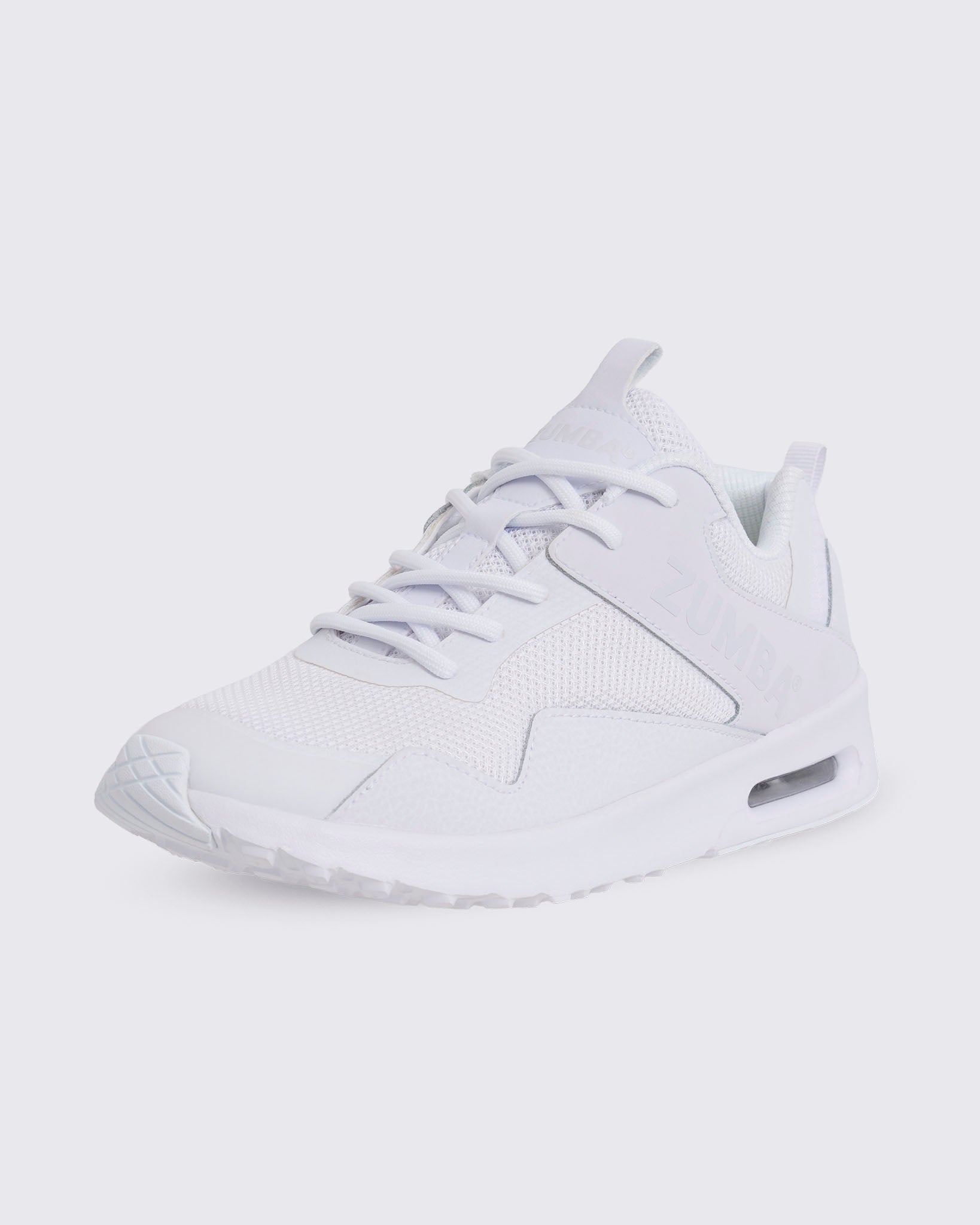 White Zumba low-top athletic sneaker in a front side view, featuring a mesh upper, tonal laces, layered synthetic overlays, embossed side branding, and a thick sole with visible air cushioning.