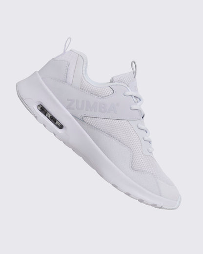 White Zumba low-top athletic sneaker shown from the opposite side, with textured mesh panels, white laces, embossed side logo, and thick white sole with a visible air unit.