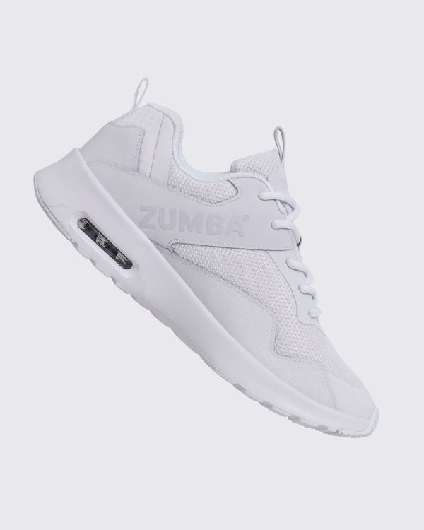 White Zumba low-top athletic sneaker shown from the opposite side, with textured mesh panels, white laces, embossed side logo, and thick white sole with a visible air unit.
