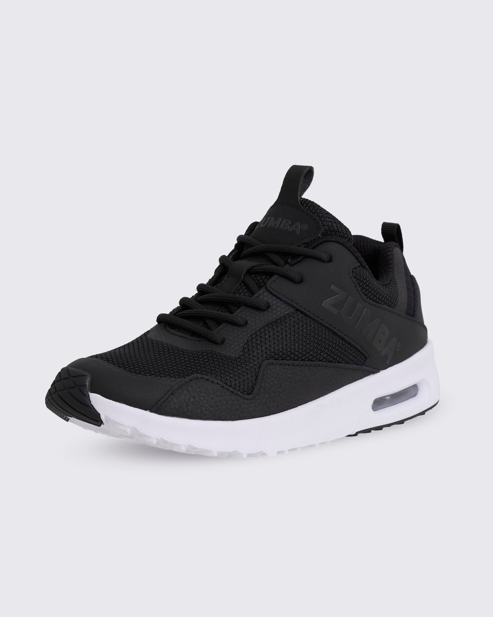 Black Zumba low-top athletic sneaker in a front side view, featuring a mesh upper, tonal laces, layered synthetic overlays, embossed side branding, and a thick white sole with visible air cushioning.