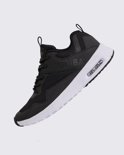 Black Zumba low-top athletic sneaker shown in a side angle, featuring a breathable mesh upper, tonal lace-up closure, embossed Zumba logo, and chunky white sole with visible air cushioning.