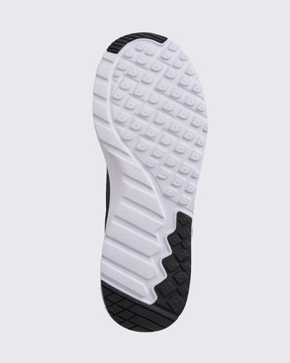 Black Zumba sneaker outsole view, highlighting the full tread pattern with square grip lugs, flex grooves, and black rubber traction zones.