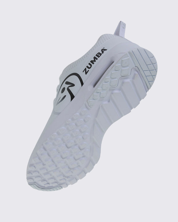 Bottom angled view of a white Zumba sneaker with a large black Zumbito and black Zumba text and a view of the white textured sole.