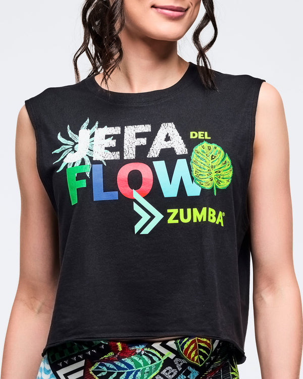 Close-up of the black sleeveless cropped tank showing the “JEFA DEL FLOW ZUMBA” graphic with bold multicolor letters, arrow detail, and leaf icons.
