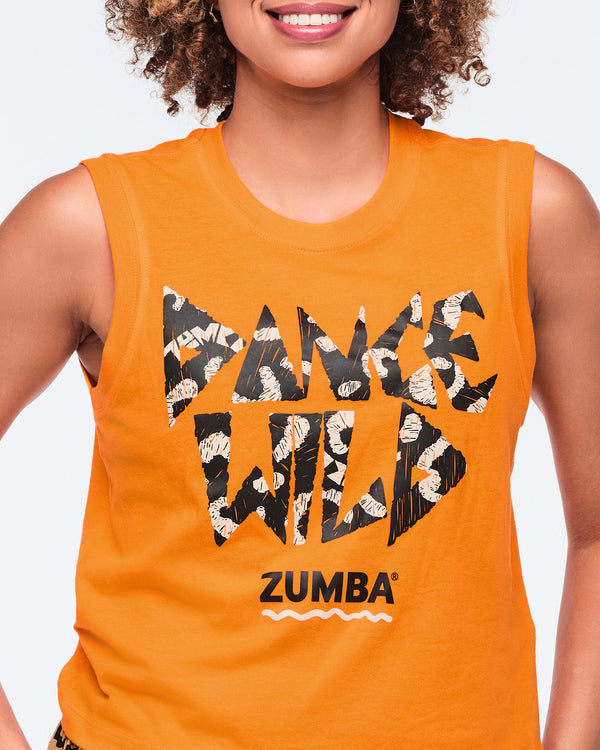 Orange sleeveless tank top with bold “Dance Wild” graphic lettering and a black Zumba logo on the front, shown on a smiling female model.
