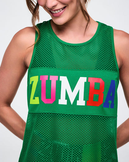 Close-up of a female model wearing a green mesh Zumba tank top with colorful letters saying 'Zumba' on a white background.