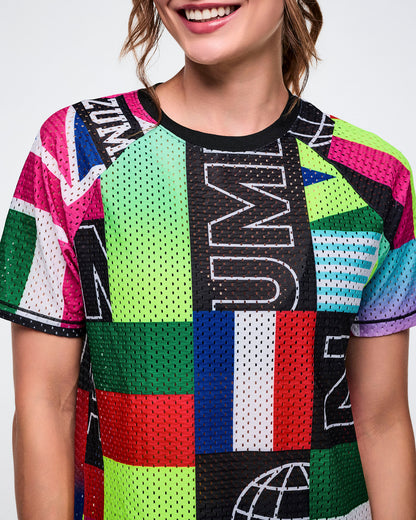 Close-up view of a female model wearing a colorful mesh crew neck top.