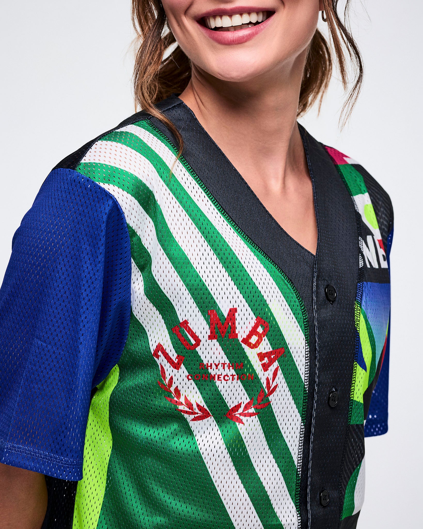 Close-up of the right side showing a Zumba logo in red and showing the mesh and buttons against a white background.