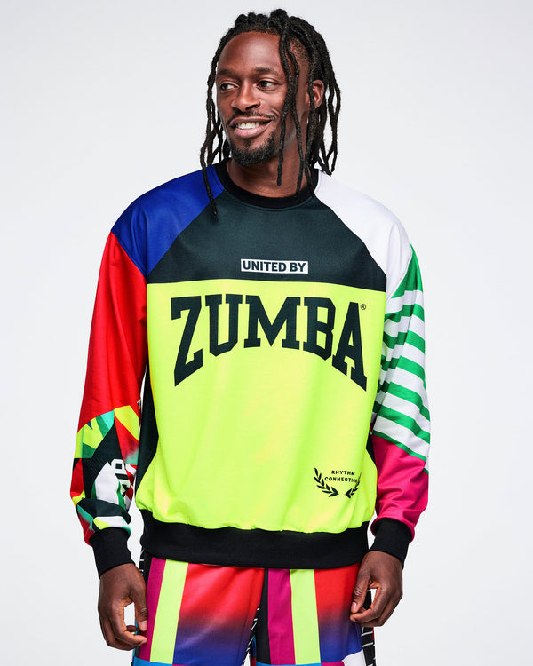 Male model wearing a colorful Zumba top with a white background.