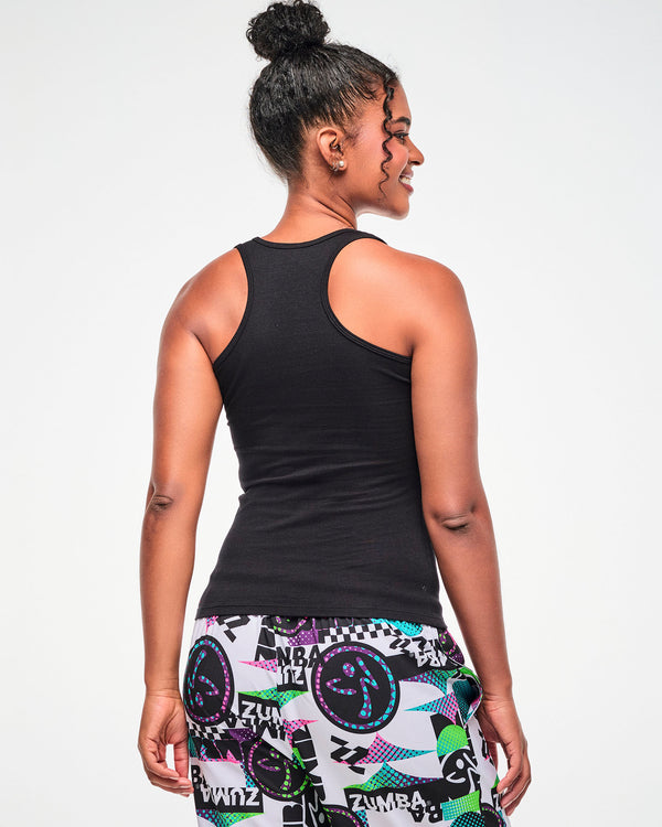 Shown from the back, female model wearing a black ribbed tank, paired with white multicolor 