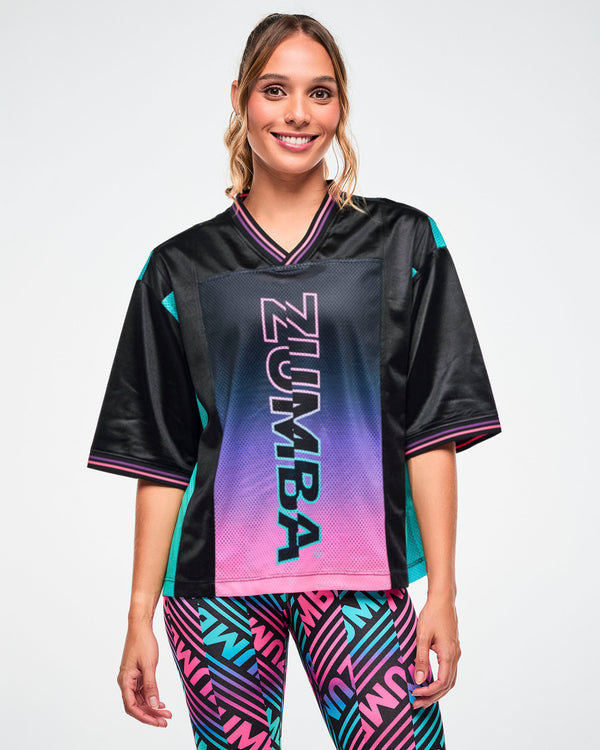 Female model wearing a black jersey tee with an aqua side panel and pink-to-purple gradient 
