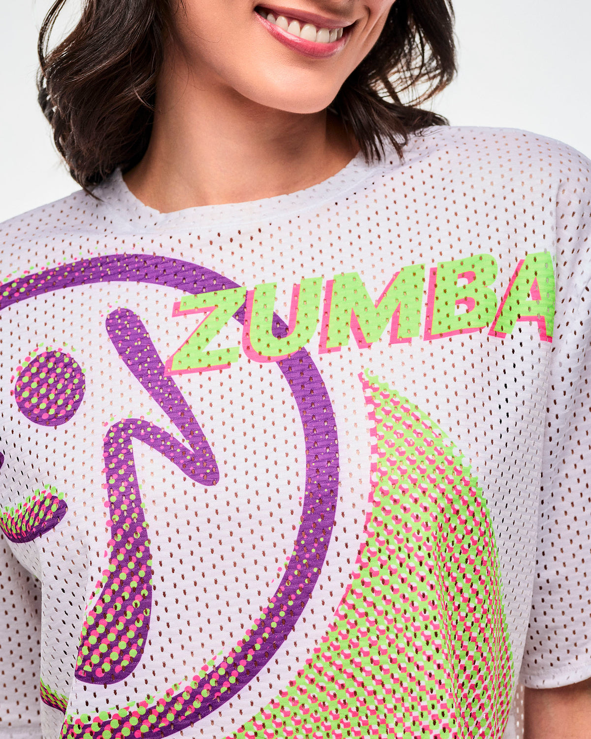 Close-up of the purple and green "Zumbito" with "ZUMBA" text in green,  outlined in pink.