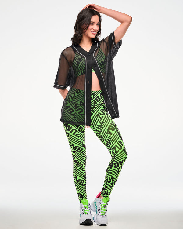 Female model wearing a black mesh mostly unbuttoned baseball-style jersey over a green and black 