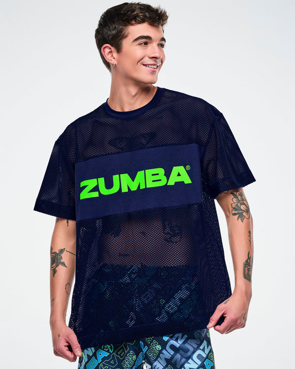 Male model wearing an indigo Zumba mesh top with “Zumba” in green text.