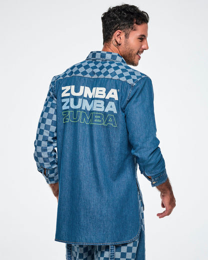 Back view of a male model wearing a denim button-down with a longer back hem and a checkerboard left sleeve, featuring "ZUMBA" repeated three times below the yoke — white, then light blue, then outlined in neon green.