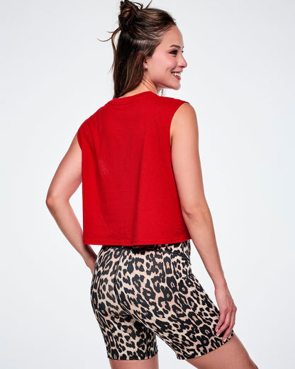 A female model shown from the back wearing a bright red sleeveless crop top and leopard-print biker shorts against a white background.