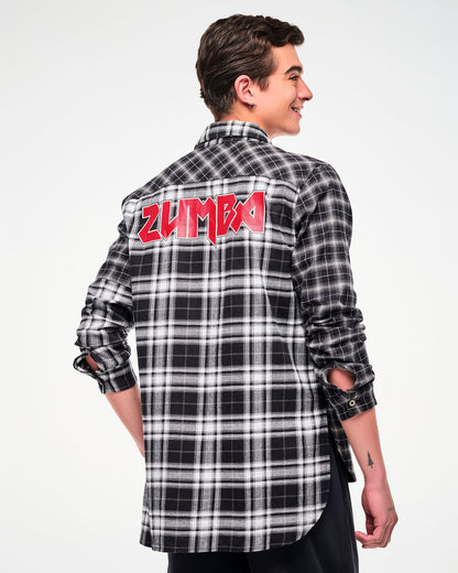A male model shown from the back, wearing a black and white plaid button-down shirt with a red rock-like 'ZUMBA' text across the upper back.